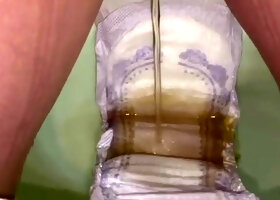 Soaking a huge pad with piss